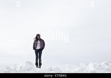 woman standing in snow, Wyoming, USA Stock Photo