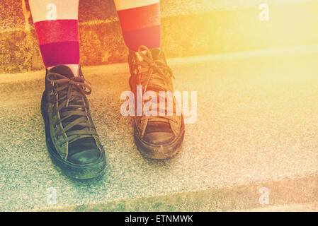 Young Punk Rock Woman with Weathered Sneakers, Urban Lifestyle,  Toned Image Stock Photo
