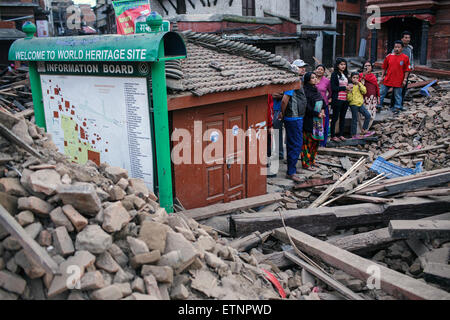 Durbar Square on the second day after the earthquake. People at World Heritage sign. Kathmandu, Nepal. 26 April 2015. Stock Photo