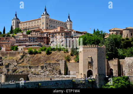 Looking up at the Alcazar with Alcantara bridge over the river Tagus, Toledo, Spain