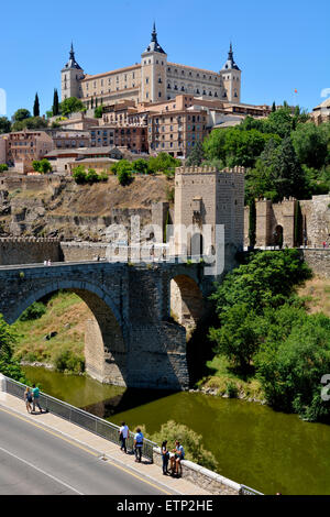 Looking up at the Alcazar with Alcantara bridge over the river Tagus, Toledo, Spain