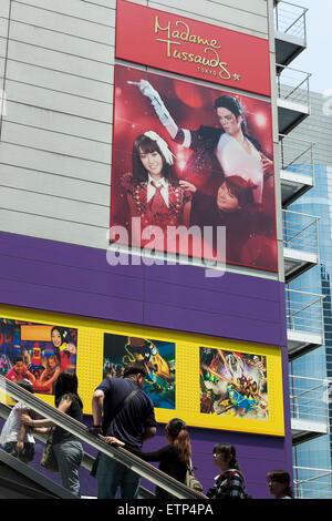 Odaiba, Tokyo. 15th June, 2015. Visitors look at a big advertisement on display outside the Madame Tussauds Tokyo wax museum in Odaiba, Tokyo, June 15, 2015. The world famous British wax museum ''Madame Tussauds'' opened its 14th permanent branch in Tokyo in 2013 and exhibits international and local celebrities, sports players and politicians. New additions to the collection include wax figures of the Japanese figure skater Yuzuru Hanyu and the actor Benedict Cumberbatch. The wax figure of Benedict Cumberbatch will be exhibited until June 30th. © Rodrigo Reyes Marin/AFLO/Alamy Live News Stock Photo