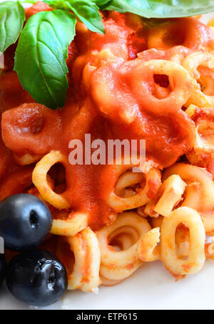 small rings of  Sicilian pasta with olive and capers tomatoes Stock Photo