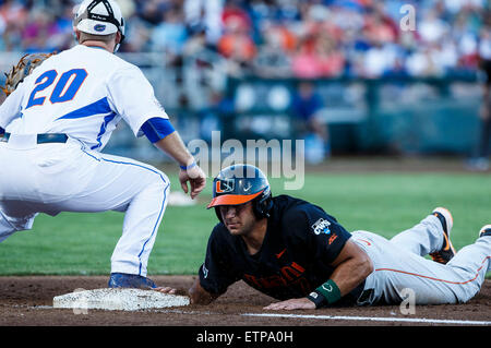 Omaha, NE, USA. 13th June, 2015. Miami infielder George Iskenderian #7 slides safely back to 1st base in action during game 2 of the 2015 NCAA Men's College World Series between Miami Hurricanes and Florida Gators at TD Ameritrade Park in Omaha, NE.Florida 15-3.Today's attendance: 26,377.Michael Spomer/Cal Sport Media. © csm/Alamy Live News Stock Photo