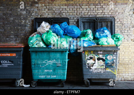 Refuse bins over flow with waste, Southwark, London, UK. London garbage. Trash bags UK. Trash bin. Trash UK. Stock Photo