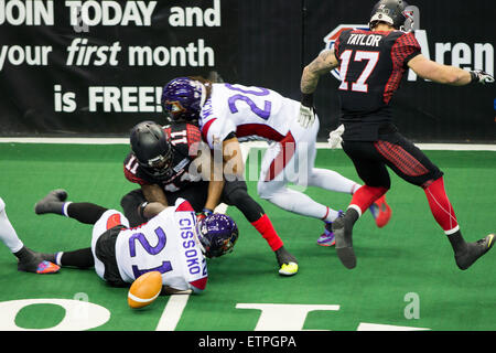 New Orleans, LA, USA. 12th June, 2015. Cleveland Gladiators wr Amarri Jackson (11) has the ball stripped of the ball by New Orleans VooDoo lb Boubacar Cissoko (21) during the game between the Cleveland Gladiators and New Orleans VooDoo at Smoothie King Center in New Orleans, LA. Stephen Lew/CSM/Alamy Live News Stock Photo