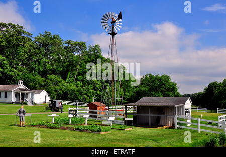 Lancaster, Pennsylvania:  Traditional windmill and farm buildings with one room schoolhouse at left at the Amish Village * Stock Photo