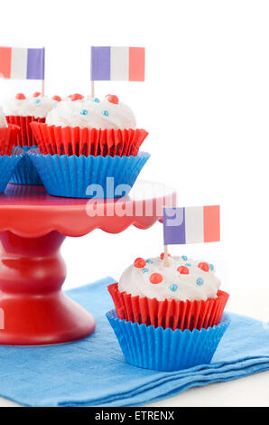 Red, white and blue theme cupcakes on white wood table for Bastille Day or French party celebration. Stock Photo