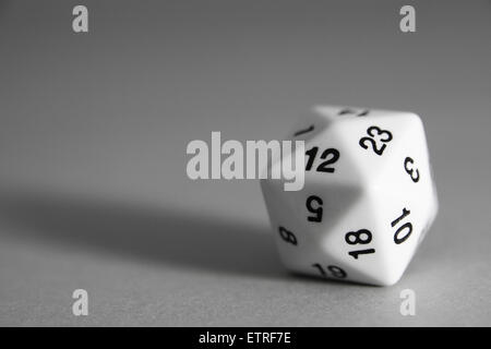 A white Tetrakis hexahedron die on grey background Stock Photo