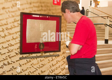 London,UK. 15th June 2015.Visitors at the British Library view a facsmile representation of the Magna Carta manuscript Credit:  amer ghazzal/Alamy Live News Stock Photo