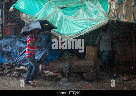 Dhaka, Bangladesh. 15th June, 2015. A boy walking on road during heavy rain in Dhaka Credit:  zakir hossain chowdhury zakir/17�Թ����� Live News Stock Photo