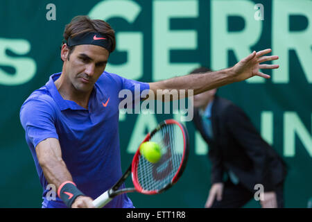 Roger Federer (SUI) plays a shot in the first round of the Gerry Weber Open. Federer won 7-6, 3-6, 7-6. Stock Photo