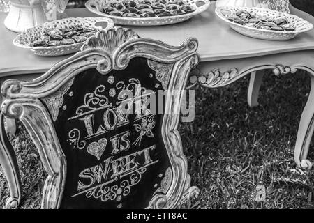 DIY wedding Love is sweet hand written sign Stock Photo