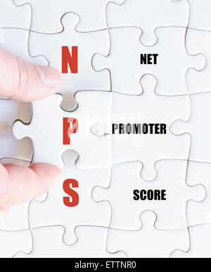 Hand of a business man completing the puzzle with the last missing piece.Concept image of Business Acronym NPS as Net Promoter Score Stock Photo