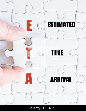 Hand of a business man completing the puzzle with the last missing piece.Concept image of Business Acronym ETA as Estimated Time Arrival Stock Photo