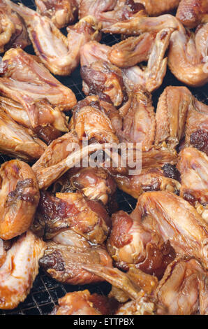 Raw honey chicken wings on BBQ grill Stock Photo