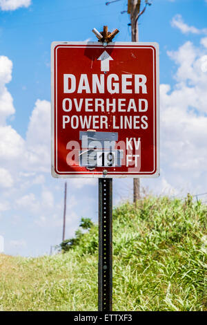Sign warning of Danger, Overhead Power Lines in rural Oklahoma, USA. Stock Photo
