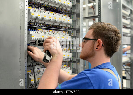 Worker in a switchboard construction factory Stock Photo