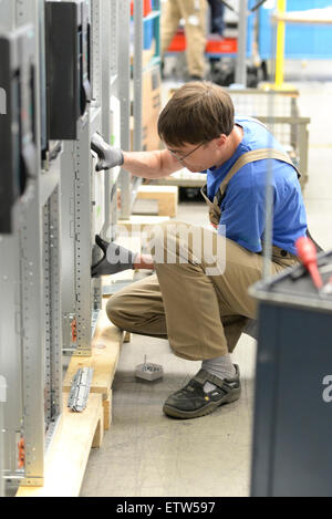 Worker in a switchboard construction factory Stock Photo