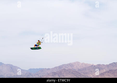 Eylat , Israel - June 6, 2015:  Kitesurfer in the air on a board on the background of the mountains of Jordan. Gulf of Eilat, th Stock Photo