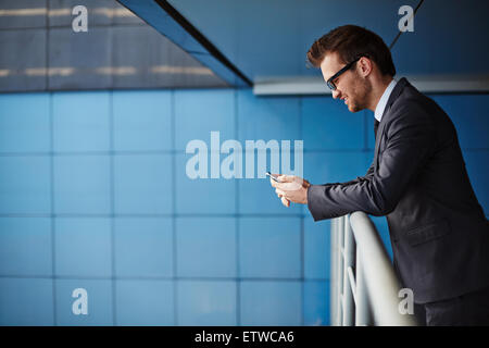 Businessman in formalwear using cellphone Stock Photo