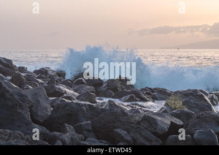 Wave breaking on big stones of Tenerife island coast, Spain Stock Photo