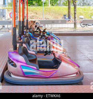 Colorful bumper cars for children in line.