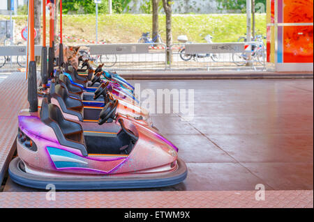 Colorful bumper cars for children in line.