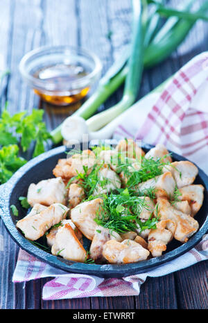 fried meat in pan and on a table Stock Photo