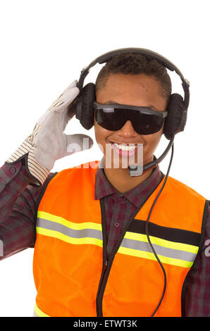 Hispanic industry worker with headphones, sunglasses and gloves in front of camera Stock Photo