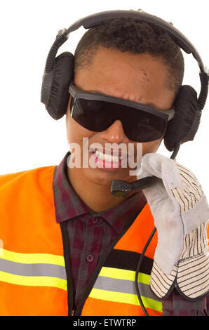 closeup hispanic industry worker with headphones, sunglasses and gloves in front of camera Stock Photo