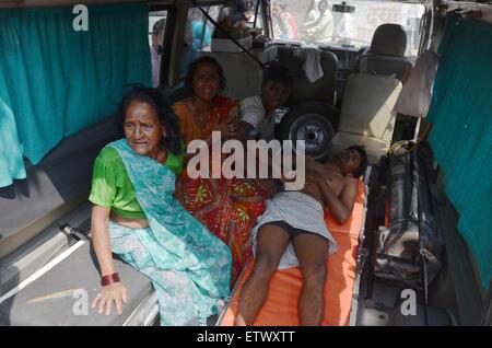 Allahabad, India. 16th June, 2015. An injured Indian is being carried to the hospital after the Jaguar fighter aircraft of the Indian Air Force crashed this morning at Chaka in Naini near Allahabad in Uttar Pradesh. Both the pilots managed to eject safely. The plane which had taken off at 7:25 am from the Bamrauli air strip in Allahabad was on a routine training sortie. The pilots reportedly sent signals to the ground staff that there was some major technical glitch with the aircraft. Credit:  PACIFIC PRESS/Alamy Live News Stock Photo