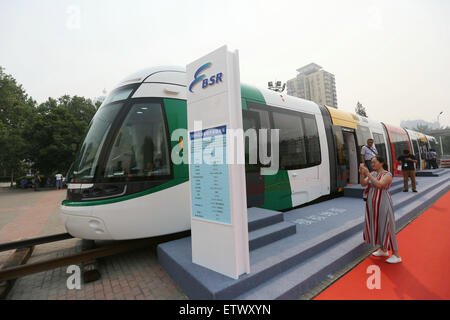 Beijing, China. 16th June, 2015. A woman takes pictures at the BSR exhibition stand at the UrTran 2015 International Urban Rail Exhibition in Beijing, capital of China, June 16, 2015. The three-day UrTran 2015 exhibition kicked off at China International Exhibition Center in Beijing Tuesday. Credit:  Xinhua/Alamy Live News Stock Photo