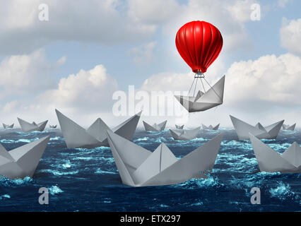 Business advantage concept and game changer symbol as an ocean with a crowd of paper boats and one boat rises above the rest with the help of a red hot air balloon as a success and innovation metaphor for new thinking. Stock Photo