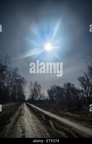 Moon flover -unusual full moon halo light with night country road Stock Photo