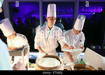 Hong Kong, China, Cook reaches a guest a plate of pancakes Stock Photo