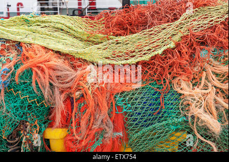 Mass of dry weathered fishing nets with mesh of different sizes a mixture of old and new nylon net Stock Photo