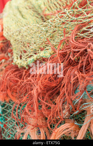Mass of dry weathered fishing nets with mesh of different sizes a mixture of old and new nylon net Stock Photo