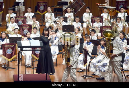 Beijing, China. 16th June, 2015. Bandsmen of a student wind band from Beijing No. 2 Experimental Primary School perform at the National Center for the Performing Arts in Beijing, capital of China, June 16, 2015. The school band concert is held here Tuesday. Credit:  Wu Xiaoling/Xinhua/Alamy Live News Stock Photo