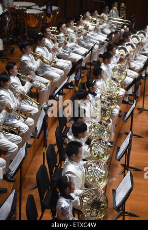 Beijing, China. 16th June, 2015. Bandsmen of a student wind band from Beijing No. 2 Experimental Primary School perform at the National Center for the Performing Arts in Beijing, capital of China, June 16, 2015. The school band concert is held here Tuesday. Credit:  Wu Xiaoling/Xinhua/Alamy Live News Stock Photo