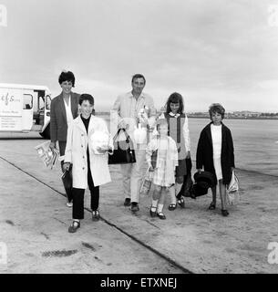 Spike Milligan and family back from a three week holiday in Marbella, pictured at London Airport. Pictured are, Spike with his wife Paddy and children from Spike's previous marriage, Sean (10), Sile (7) and Laura (12), also with them is the children's nan Stock Photo