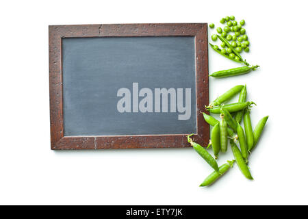 blank chalkboard and green peas on white background Stock Photo