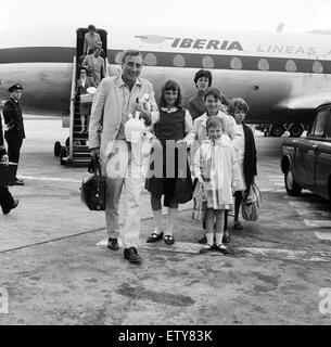 Spike Milligan and family back from a three week holiday in Marbella, pictured at London Airport. Leaving the aircraft, Spike with his wife Paddy and children from Spike's previous marriage, Laura (12) Sean (10) and Sile (7) also with them is the children Stock Photo