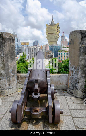 Canon in historic Monte Fort castle with the Grand Lisboa Casino in distance in Macau China Stock Photo