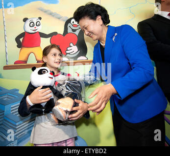 Prague, Czech Republic. 16th June, 2015. Chinese Vice Premier Liu Yandong presents some gifts to a girl as she visits a local hospital in Prague, capital of Czech Republic, on June 15, 2015. Credit:  Xinhua/Alamy Live News Stock Photo