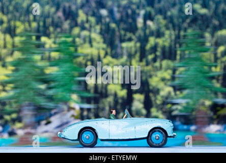 Dinky toy sports car speeding through an alpine forest Stock Photo