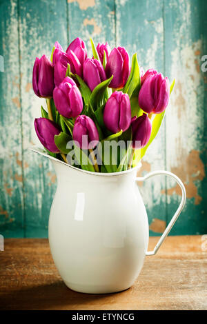 Purple Tulips on a wooden surface. Studio photography Stock Photo