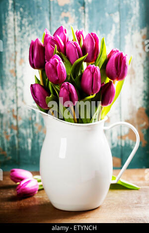 Purple Tulips on a wooden surface. Studio photography Stock Photo