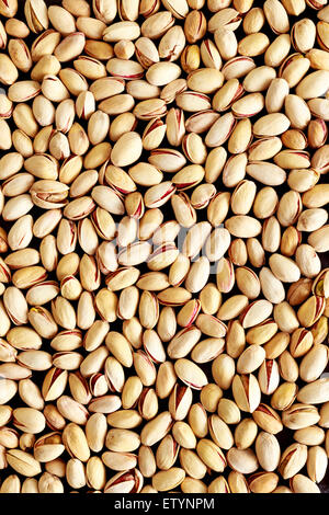 Scattered Pistachio Nuts on a Dark Background Stock Photo