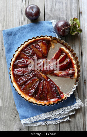 Freshly baked  plum tart on wooden board Stock Photo